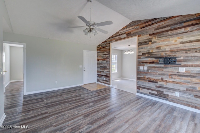 2715 Ashby Dr, Wilmington, NC 28411 - unfurnished living room with baseboards, wood finished floors, wooden walls, and ceiling fan with notable chandelier