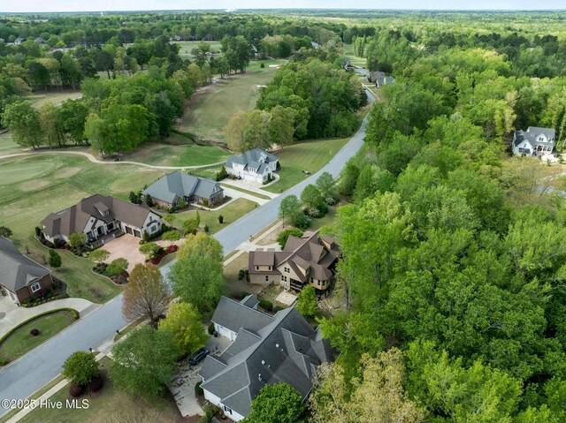birds eye view of property featuring a wooded view, a residential view, and view of golf course