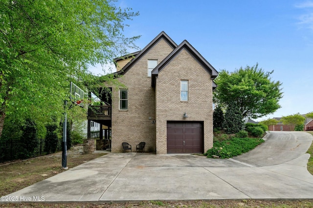 view of property exterior with an attached garage, driveway, and brick siding