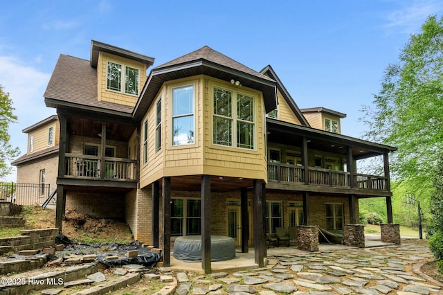 back of house with a patio, french doors, and brick siding