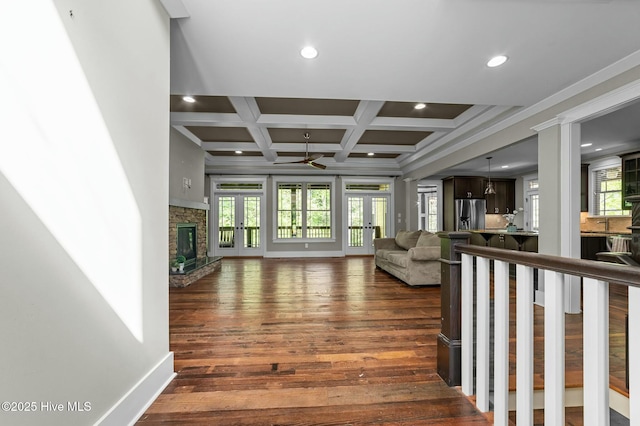 living room with dark wood finished floors, a ceiling fan, recessed lighting, coffered ceiling, and baseboards