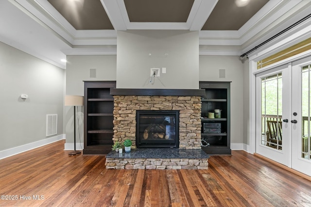 unfurnished living room featuring wood-type flooring, visible vents, baseboards, and ornamental molding