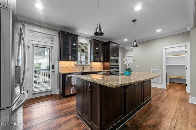 kitchen featuring dark wood-type flooring, visible vents, decorative backsplash, and appliances with stainless steel finishes