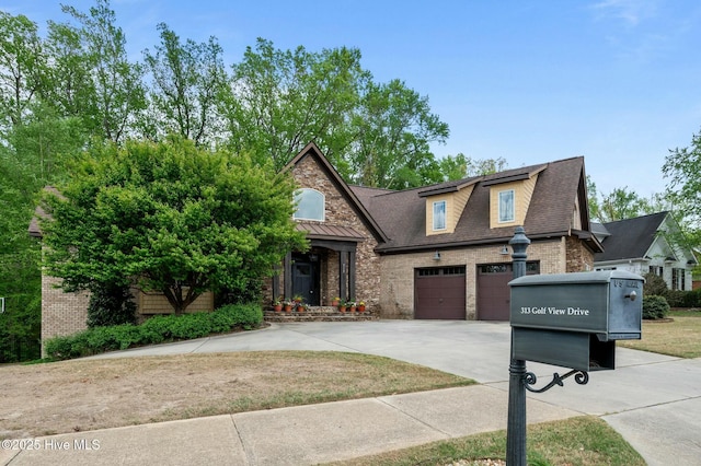 view of front of house featuring a shingled roof, concrete driveway, a garage, and brick siding