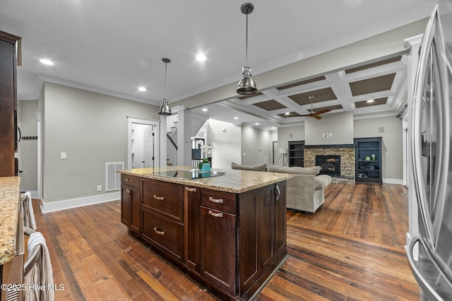 kitchen with visible vents, baseboards, black electric cooktop, dark wood-style flooring, and freestanding refrigerator