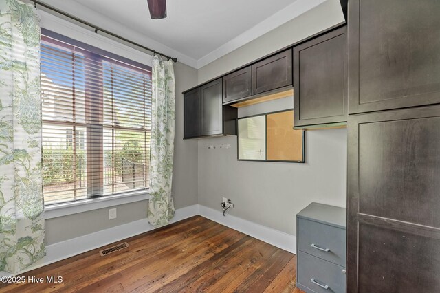kitchen with dark wood-type flooring, visible vents, baseboards, and dark brown cabinets