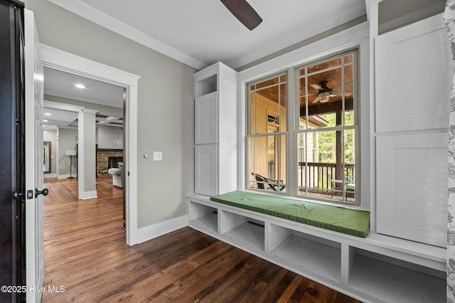 mudroom featuring ceiling fan, a fireplace, dark wood-style floors, and baseboards