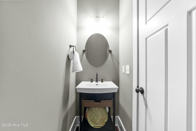 bathroom with a sink and baseboards