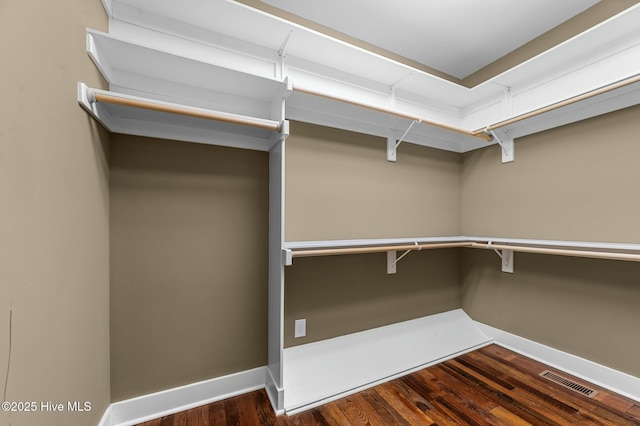 walk in closet featuring wood finished floors and visible vents