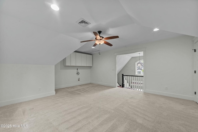bonus room with visible vents, baseboards, ceiling fan, vaulted ceiling, and light carpet