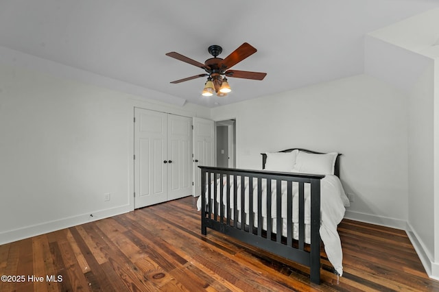 bedroom featuring a closet, baseboards, and wood finished floors