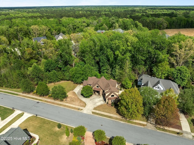 drone / aerial view with a wooded view