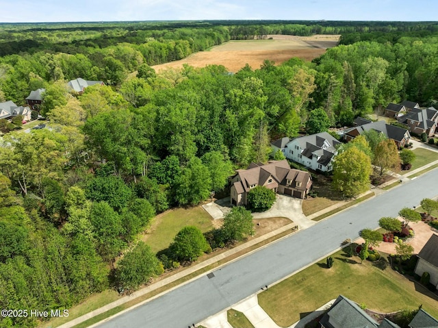 birds eye view of property with a residential view and a view of trees