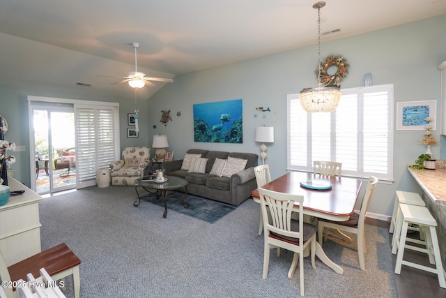 4238 Cherry Laurel Ln SE, Southport, NC 28461 - carpeted living room with lofted ceiling, a ceiling fan, and a chandelier