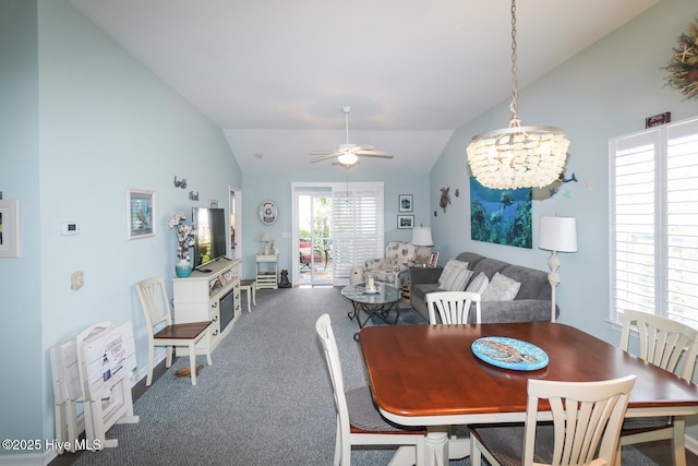 4238 Cherry Laurel Ln SE, Southport, NC 28461 - carpeted dining space featuring vaulted ceiling, a ceiling fan, and a chandelier