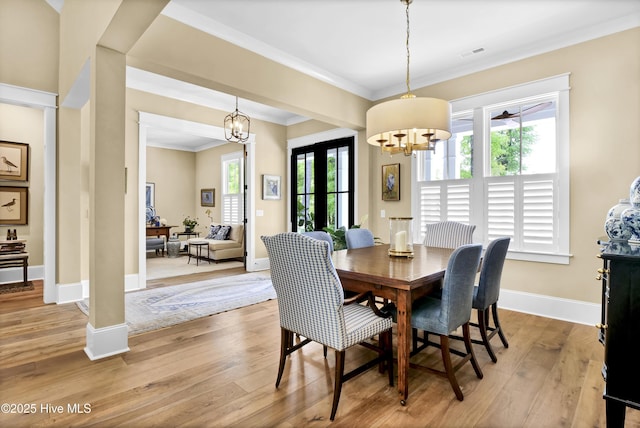 3722 White Cliffs Dr, Castle Hayne, NC 28429 - dining area with a chandelier, crown molding, light wood-style floors, and baseboards