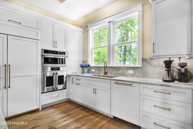3722 White Cliffs Dr, Castle Hayne, NC 28429 - kitchen with a sink, stainless steel double oven, healthy amount of natural light, and light wood-type flooring