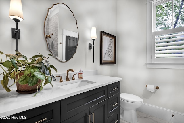 3722 White Cliffs Dr, Castle Hayne, NC 28429 - bathroom with marble finish floors, vanity, toilet, and baseboards