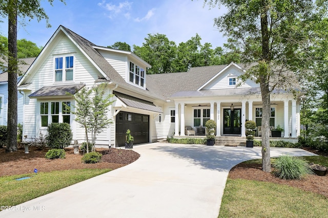 3722 White Cliffs Dr, Castle Hayne, NC 28429 - view of front of property with a porch, driveway, metal roof, a standing seam roof, and roof with shingles