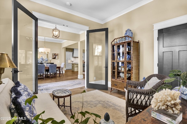 3722 White Cliffs Dr, Castle Hayne, NC 28429 - interior space featuring wood finished floors, crown molding, baseboards, and a chandelier