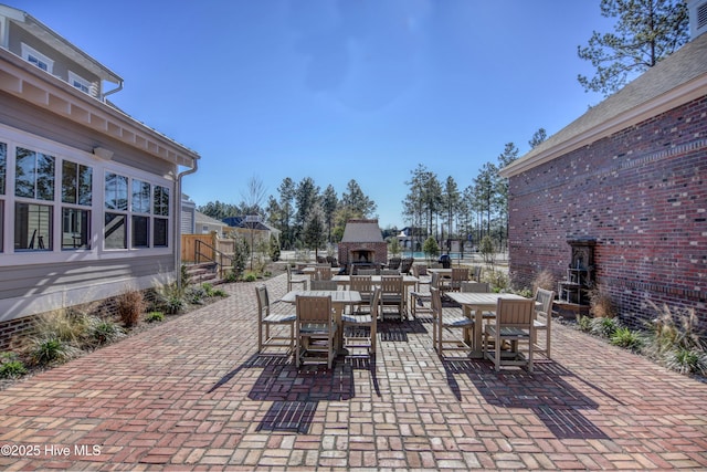 3722 White Cliffs Dr, Castle Hayne, NC 28429 - view of patio / terrace featuring exterior fireplace and outdoor dining area