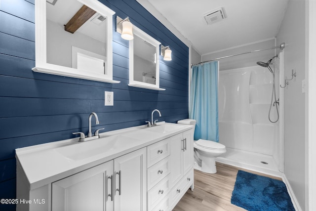 full bath with a shower with shower curtain, a sink, visible vents, and double vanity