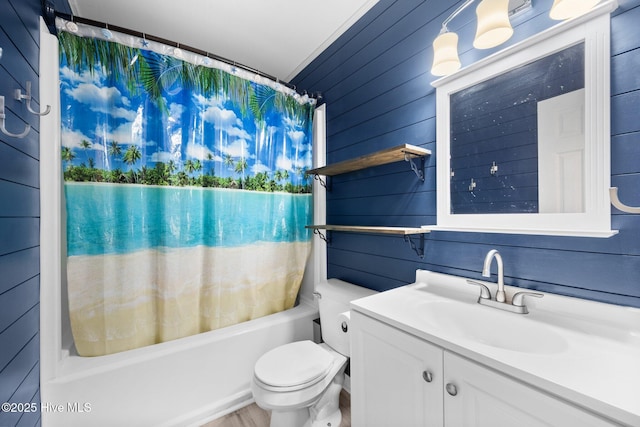 full bath featuring wood walls, shower / tub combo with curtain, vanity, and toilet