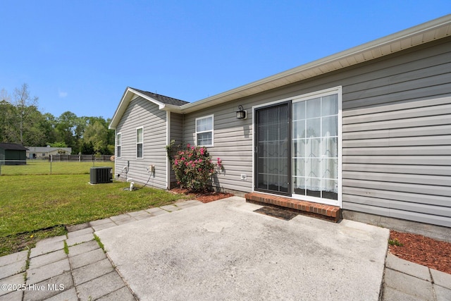 back of house with a yard, a patio area, central AC unit, and fence