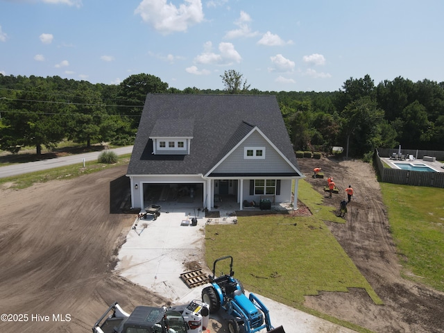 312 River Oats Ct, Holly Ridge, NC 28445 - view of front of home with driveway, covered porch, a front yard, and a shingled roof