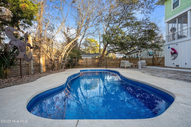 view of swimming pool featuring a fenced backyard, a patio area, and a fenced in pool