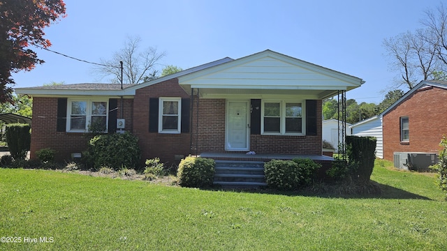 101 Oakland Blvd, Clinton, NC 28328 - view of front facade with a front yard, brick siding, cooling unit, and covered porch