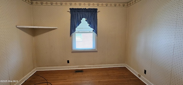 101 Oakland Blvd, Clinton, NC 28328 - empty room with dark wood-type flooring, visible vents, baseboards, and wallpapered walls