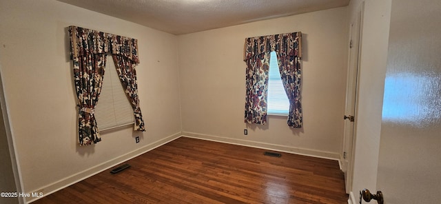 101 Oakland Blvd, Clinton, NC 28328 - empty room featuring dark wood-style floors, baseboards, and visible vents