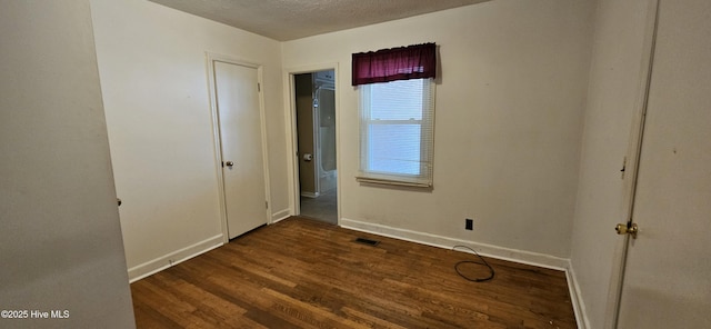 101 Oakland Blvd, Clinton, NC 28328 - unfurnished bedroom with visible vents, baseboards, wood finished floors, and a textured ceiling