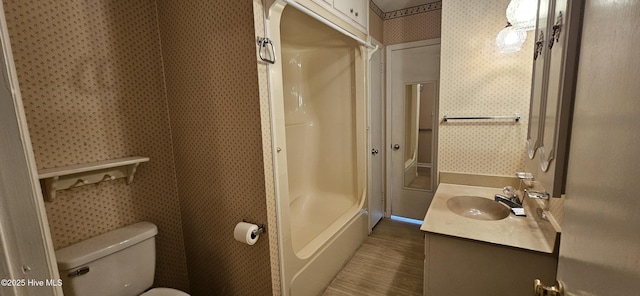 101 Oakland Blvd, Clinton, NC 28328 - full bathroom featuring vanity, wallpapered walls, walk in shower, toilet, and wood finished floors