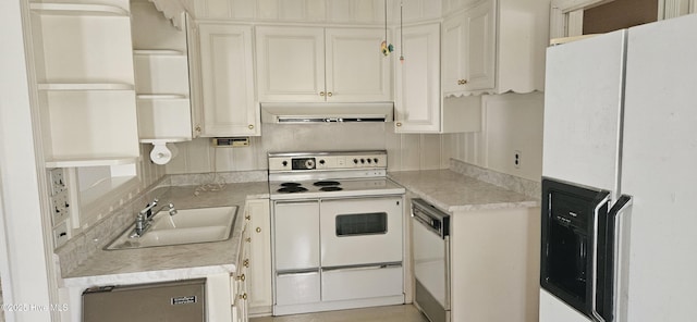 101 Oakland Blvd, Clinton, NC 28328 - kitchen featuring white appliances, white cabinets, under cabinet range hood, light countertops, and a sink