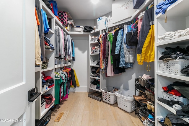 spacious closet featuring wood finished floors