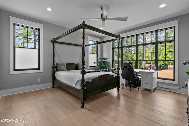 bedroom with light wood-type flooring, recessed lighting, and multiple windows