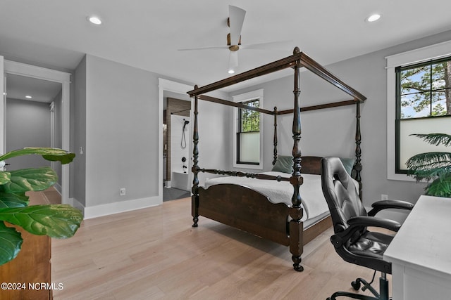bedroom with recessed lighting, light wood-type flooring, and baseboards