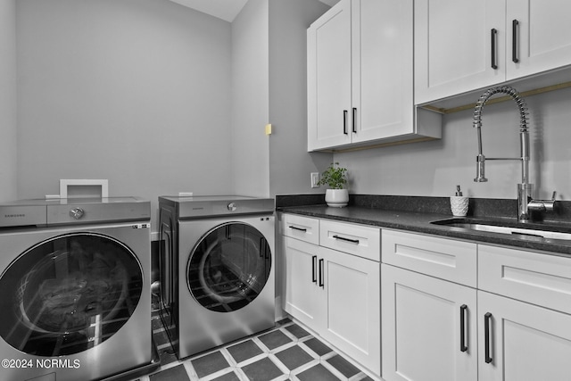 laundry area featuring independent washer and dryer, a sink, and cabinet space