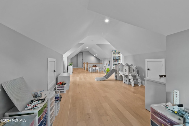 rec room with vaulted ceiling, light wood finished floors, and recessed lighting