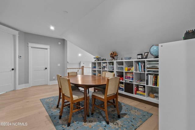 dining space with baseboards, wood finished floors, and recessed lighting