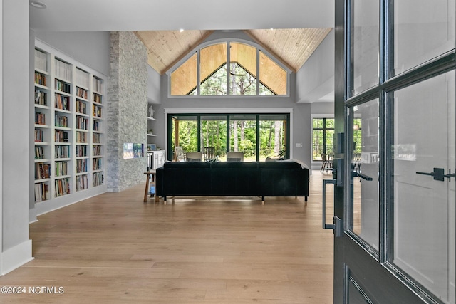 foyer with wood ceiling, wood finished floors, and high vaulted ceiling