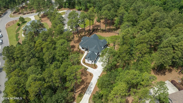 birds eye view of property with a view of trees