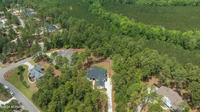 birds eye view of property featuring a view of trees and a residential view