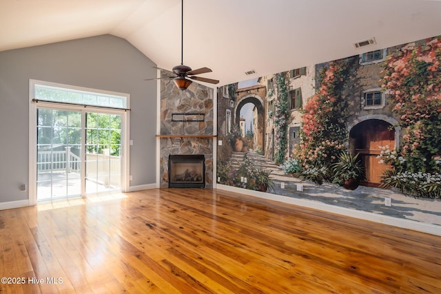 6321 Albatross Dr, New Bern, NC 28560 - unfurnished living room featuring a stone fireplace, wood-type flooring, a ceiling fan, lofted ceiling, and baseboards