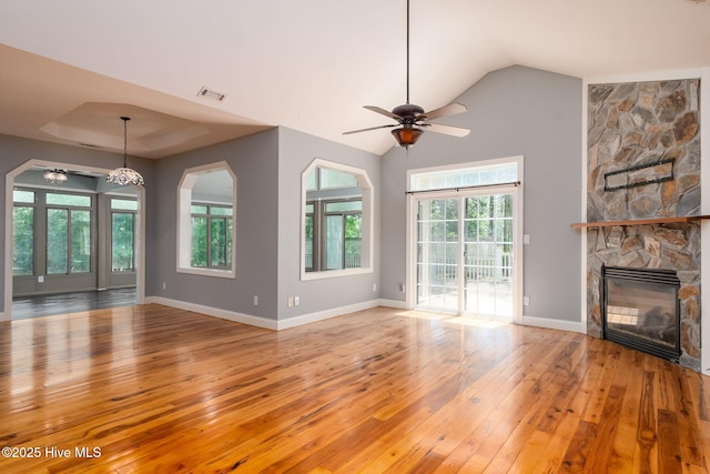 6321 Albatross Dr, New Bern, NC 28560 - unfurnished living room featuring hardwood / wood-style flooring, a ceiling fan, a stone fireplace, lofted ceiling, and baseboards