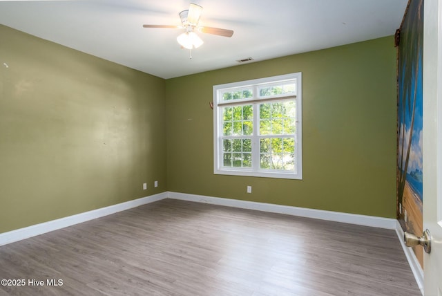 6321 Albatross Dr, New Bern, NC 28560 - empty room featuring a ceiling fan, wood finished floors, and baseboards