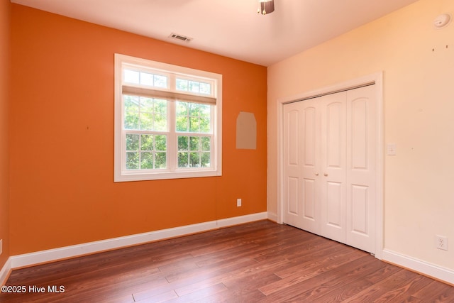 6321 Albatross Dr, New Bern, NC 28560 - unfurnished bedroom featuring multiple windows, wood finished floors, and baseboards