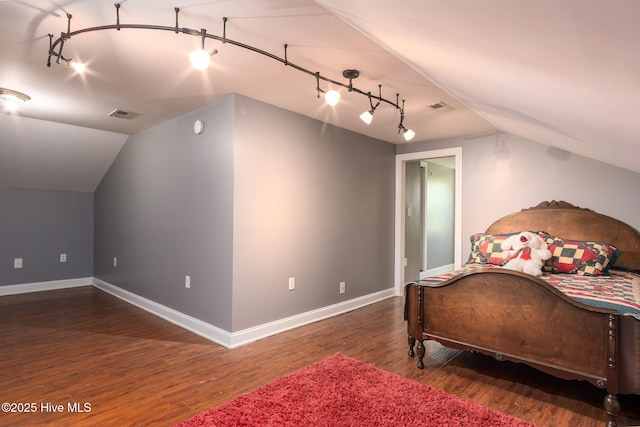 6321 Albatross Dr, New Bern, NC 28560 - bedroom with rail lighting, lofted ceiling, wood finished floors, and baseboards
